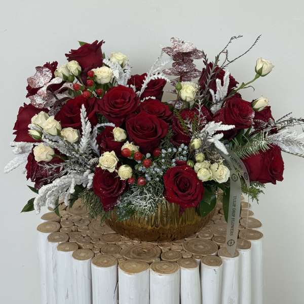 Red and white rose arrangement in a glass vase