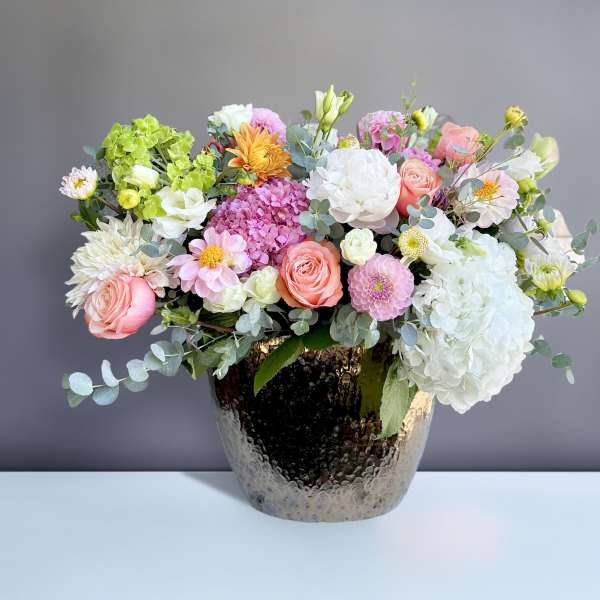 Mixed pastel bouquet in a hammered metallic vase