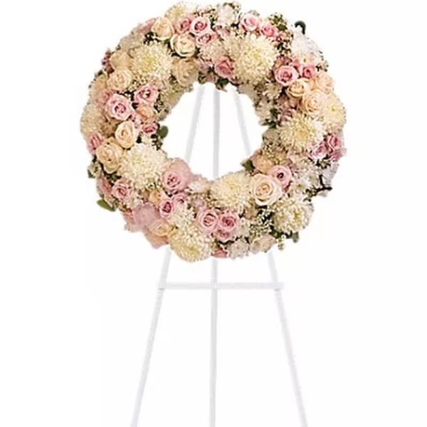 Pastel floral wreath on a white stand