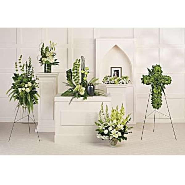 White and green floral funeral arrangements on stands and pedestals