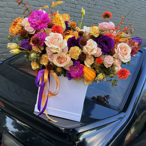 Mixed bouquet in a white gift box with purple and orange ribbons