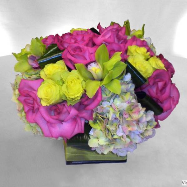 Pink and yellow rose bouquet with hydrangeas in a square vase