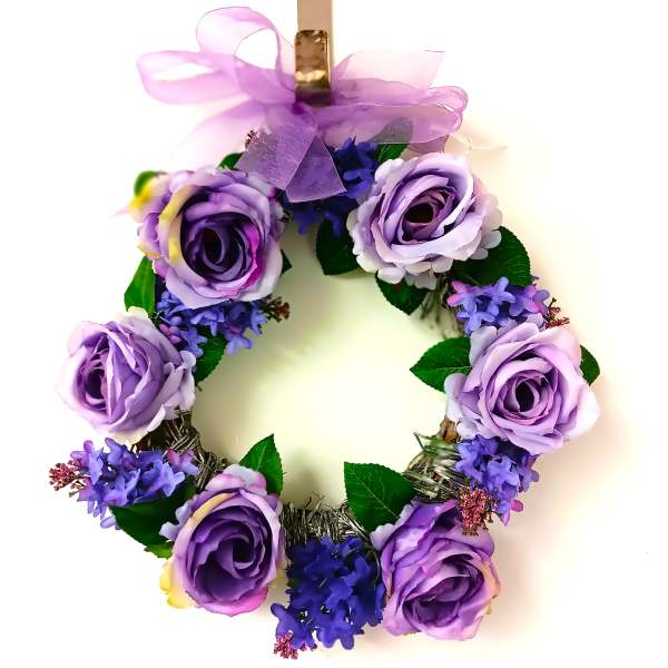 Purple floral wreath with roses and ribbon bow