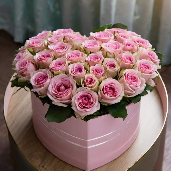 Pink roses arranged in a round pink box