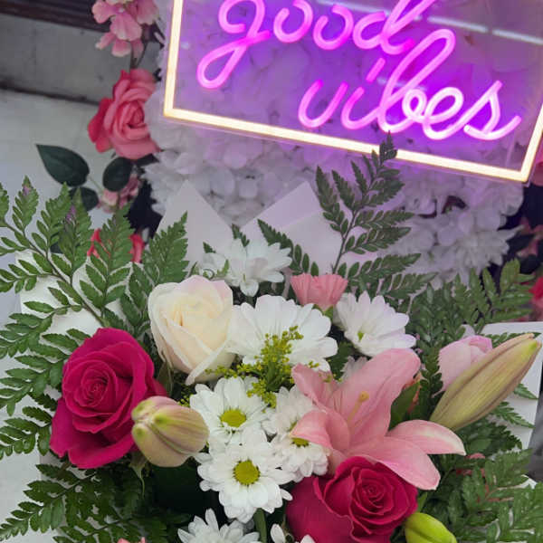 Bouquet of pink and white roses, lilies, and daisies