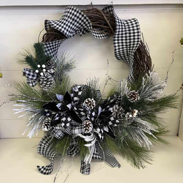 Black-and-white plaid wreath with pinecones and frosted greenery