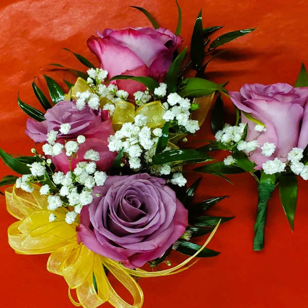 Purple rose boutonnieres with baby's breath and yellow ribbon