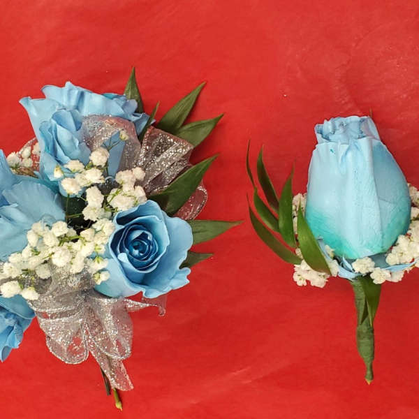 Blue rose bouquet and matching boutonniere on a red background