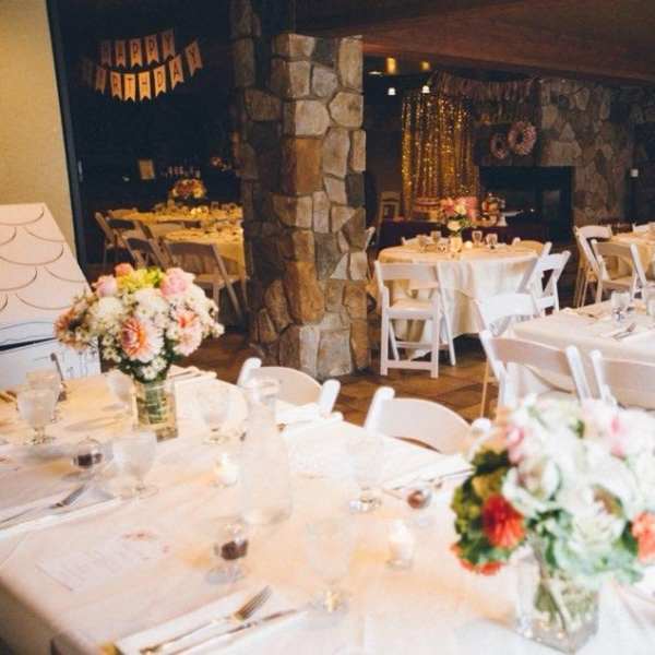 Banquet tables with floral centerpieces in a decorated reception room