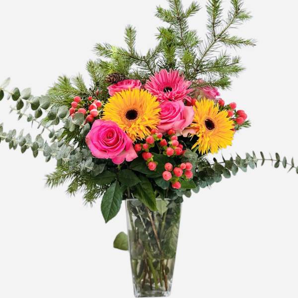 Pink roses and yellow gerbera daisies in a glass vase
