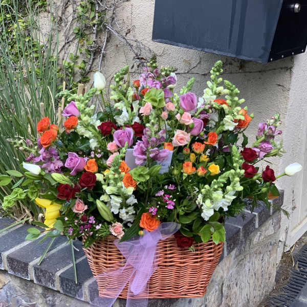 Large mixed flower basket with roses, tulips, and snapdragons