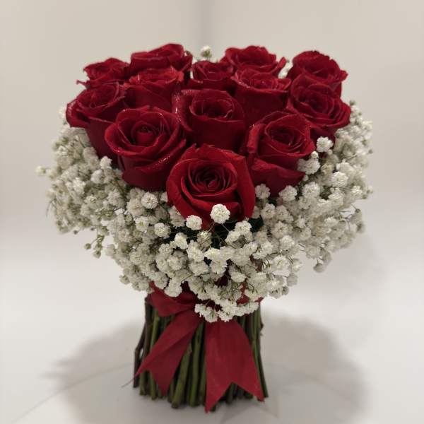 Bouquet of red roses with white baby's breath tied with a red ribbon