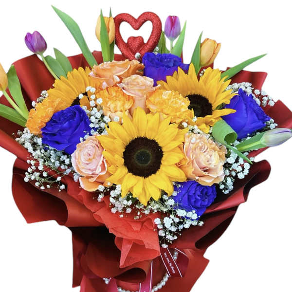 Bouquet of sunflowers, roses, and tulips wrapped in red paper