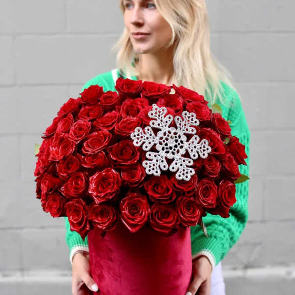 Large bouquet of red roses with a white snowflake decoration in a red box