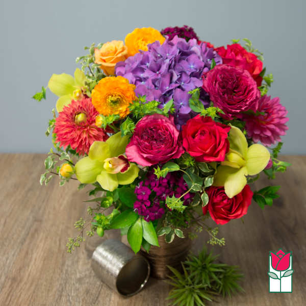 Colorful bouquet of roses, hydrangea, and orchids in a vase
