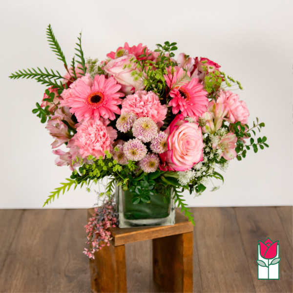 Pink mixed bouquet in a square glass vase