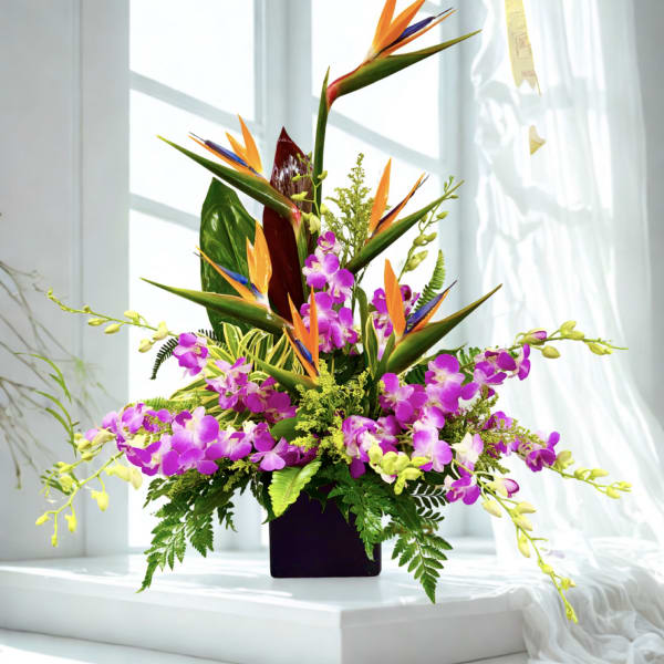Tropical flower arrangement with purple orchids and bird of paradise in a dark vase