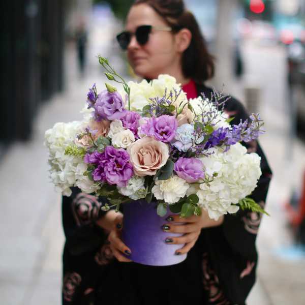 Bouquet of pastel flowers in a purple vase
