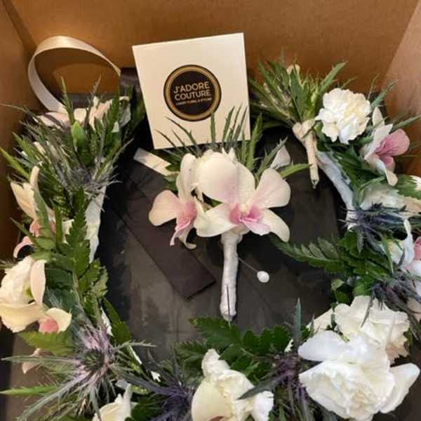 Floral wreath with white and pink orchids in a gift box