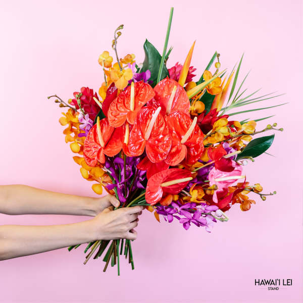Bright tropical bouquet with red anthuriums and orange orchids