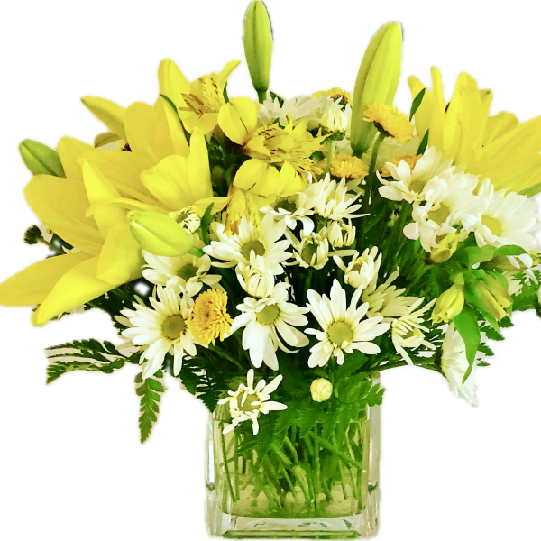 Yellow lilies and white daisies in a clear glass vase