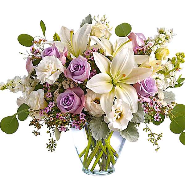 Lavender roses and white lilies in a clear glass vase