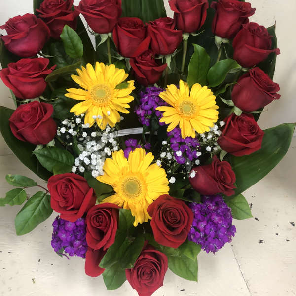 Bouquet of red roses with yellow gerbera daisies and purple filler flowers
