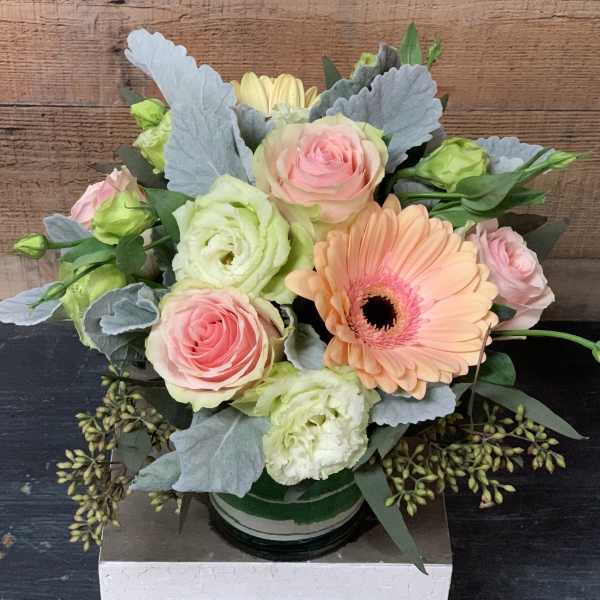 Pastel bouquet with roses, gerbera daisy, and lisianthus in a vase