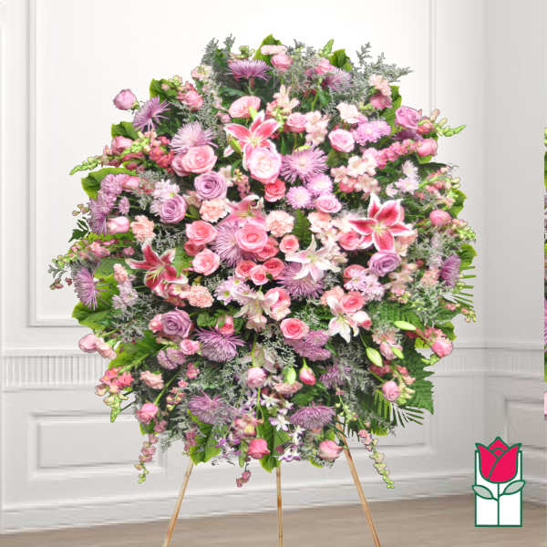 Large pink and lavender funeral spray on a stand