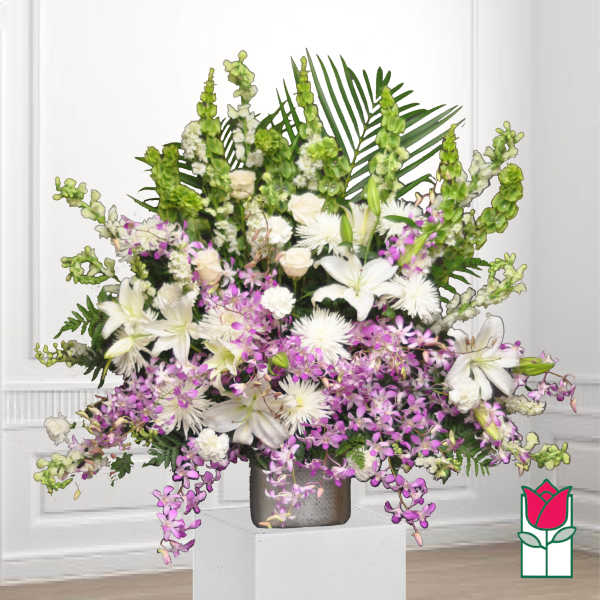 White lilies and purple orchids in a silver vase