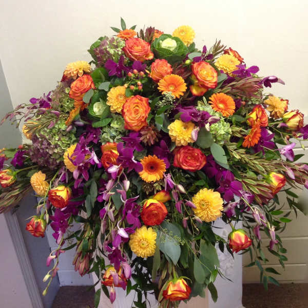 Large mixed bouquet with orange, yellow, and purple flowers