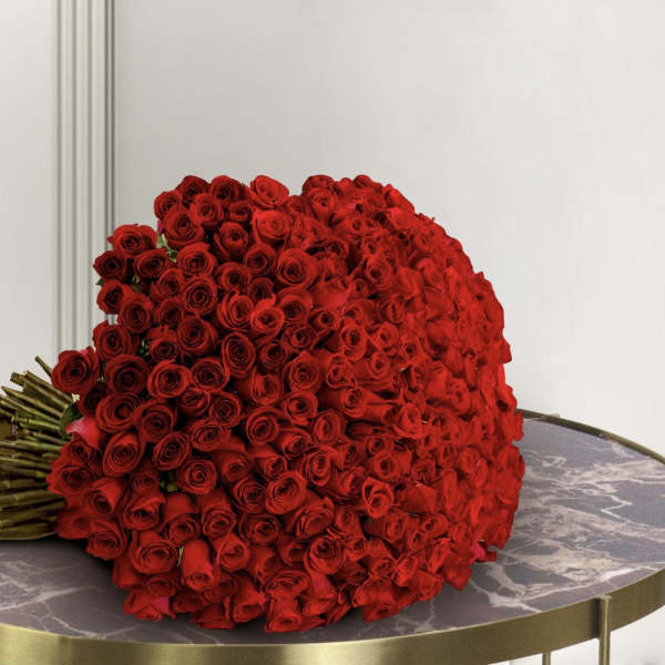 Large bouquet of red roses resting on a round table