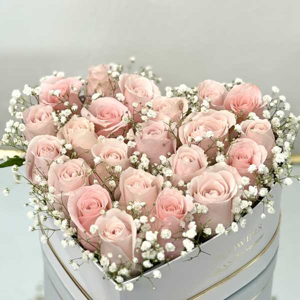 Heart-shaped box of pale pink roses with white baby's breath