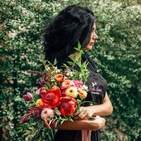 Woman holding a colorful bouquet of mixed flowers
