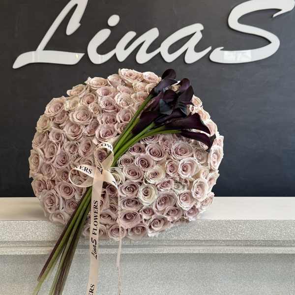 Round bouquet of pale pink roses with dark calla lilies and ribbon