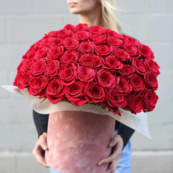 Large bouquet of red roses wrapped in pink paper