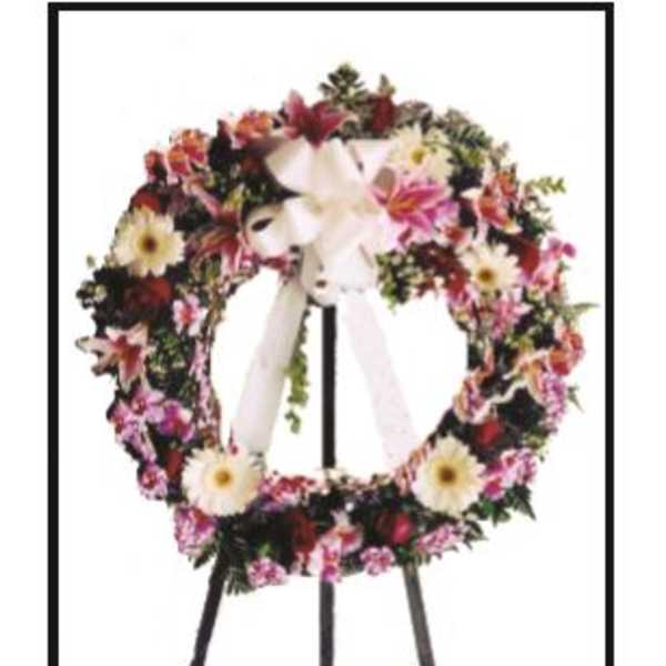 Floral wreath on a black easel with a white ribbon bow