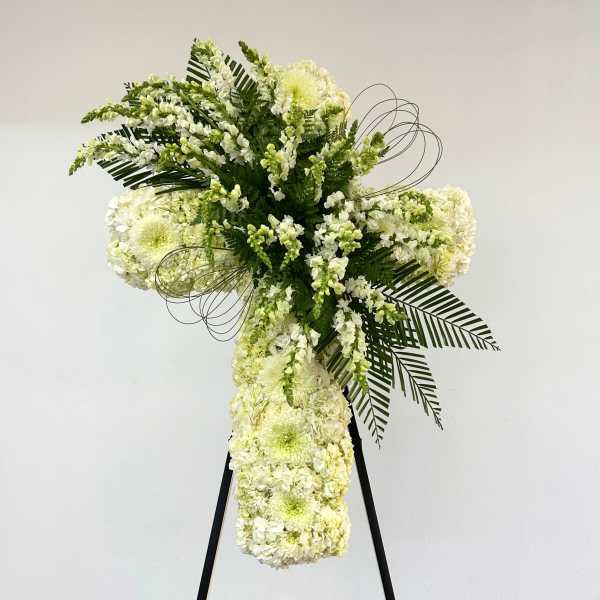 Tall white floral standing spray on a black easel