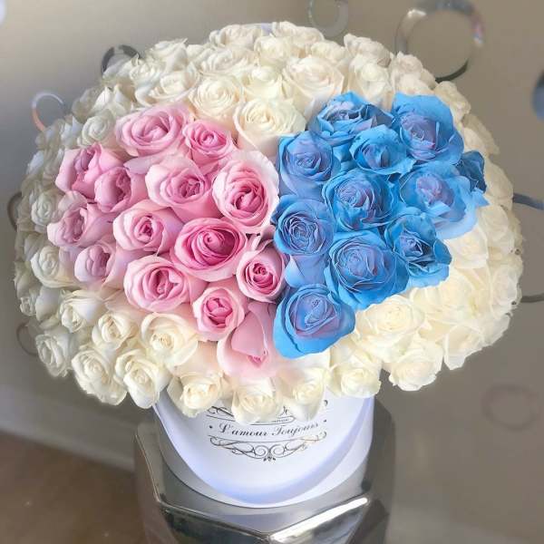Bouquet of white, pink, and blue roses in a white hat box