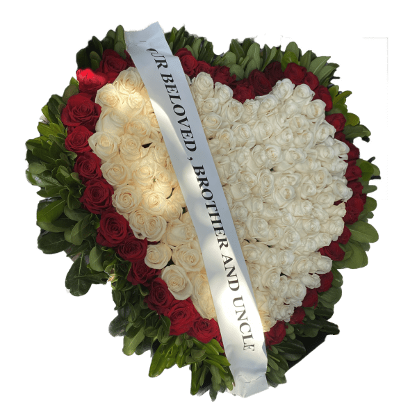 Heart-shaped rose wreath with a white memorial ribbon