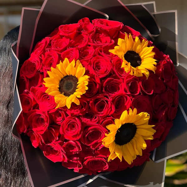 Round bouquet of red roses with yellow sunflowers