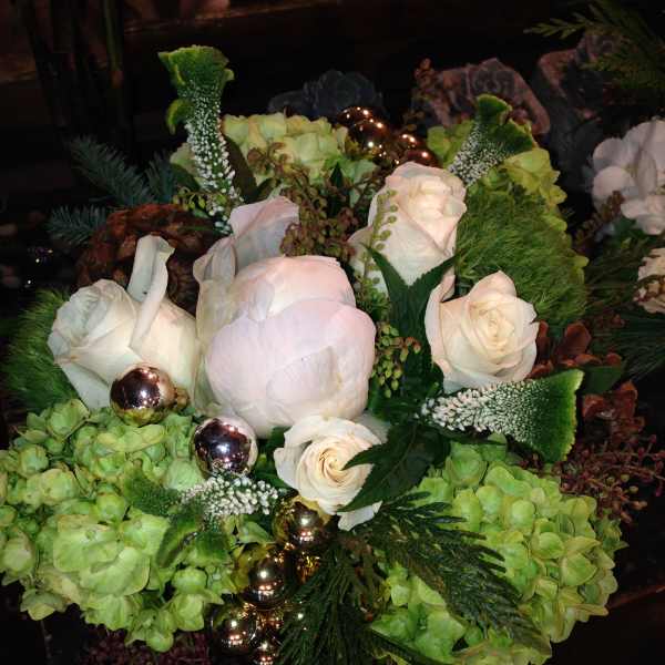 White roses and pale green hydrangeas with metallic ornaments