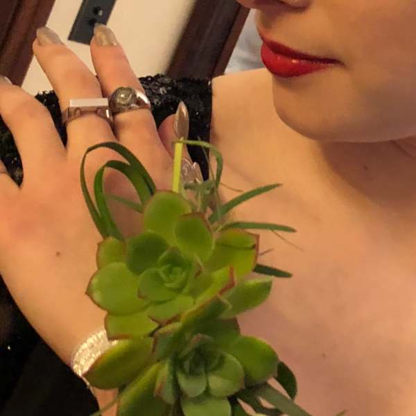 Green succulent wrist corsage on a woman's wrist