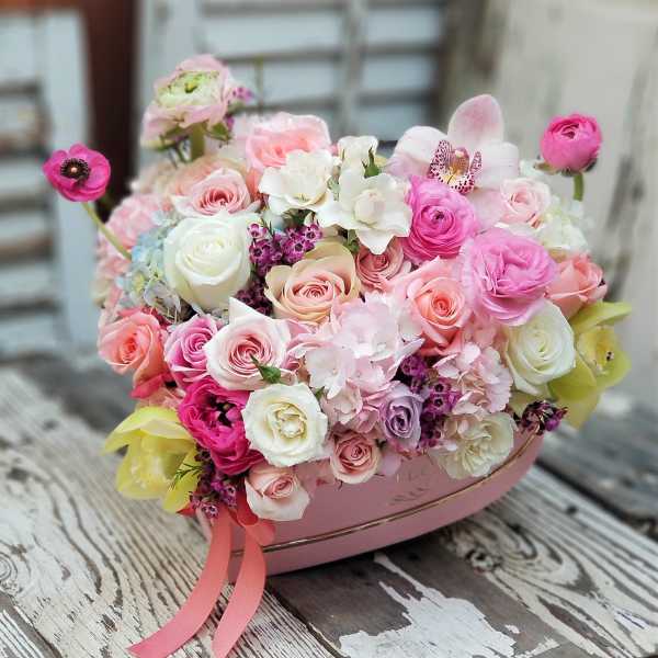 Pink and white rose bouquet in a pink heart-shaped box