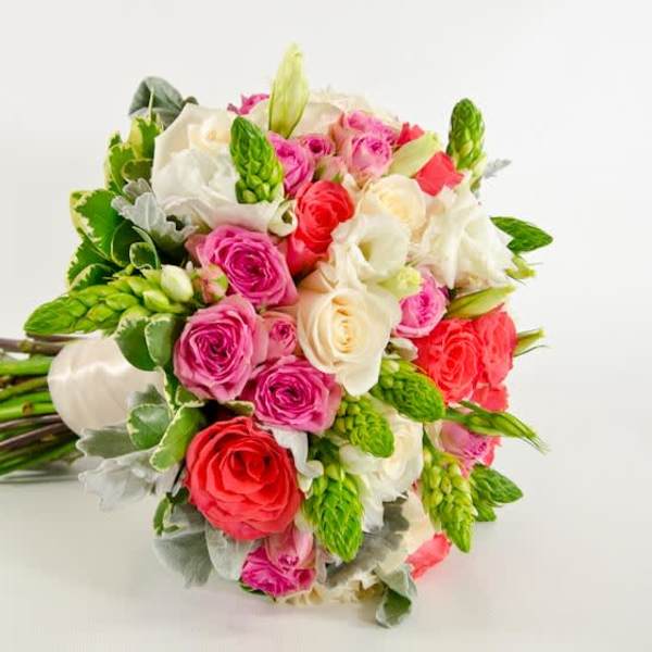 Bouquet of pink, red, and white roses with green accents