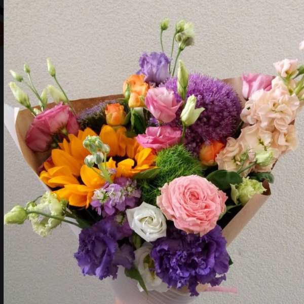 Hand-tied bouquet of pink, purple, orange, and white flowers