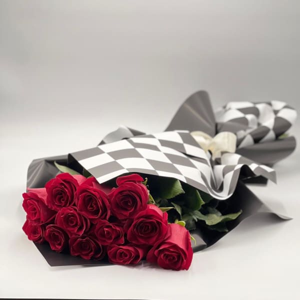 Bouquet of red roses wrapped in black and white paper