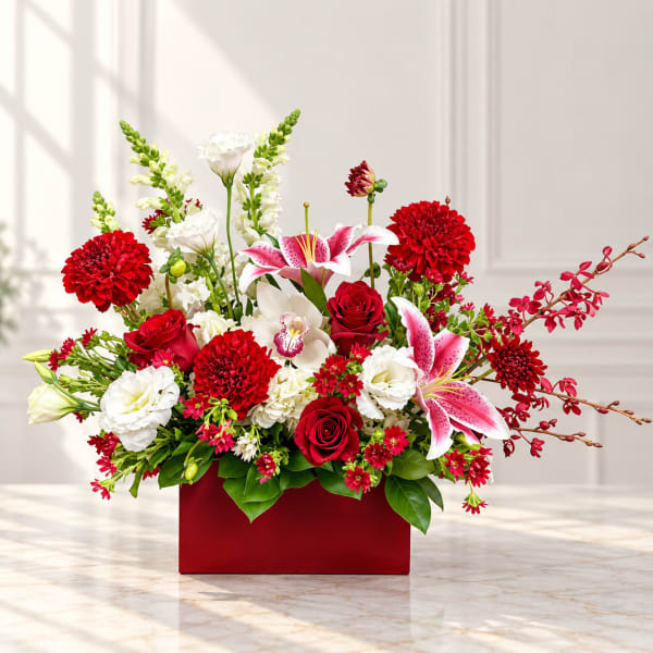 Red and white floral arrangement in a red rectangular box