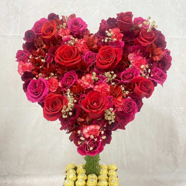 Heart-shaped rose arrangement with Ferrero Rocher chocolates on a square base