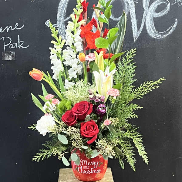 Red roses and mixed flowers in a red Christmas pot